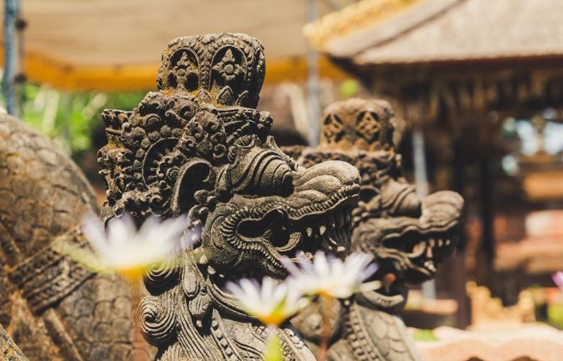 Bali Temple - two gray concrete dragon statues outdoor at daytime