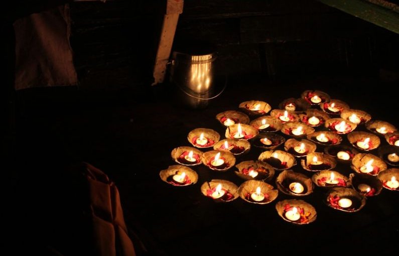 Varanasi Ganges - a bunch of lit candles sitting on top of a table